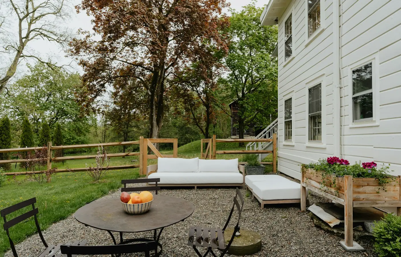 Existing white house with an open backyard where a detached accessory dwelling unit could be added (stock photo)