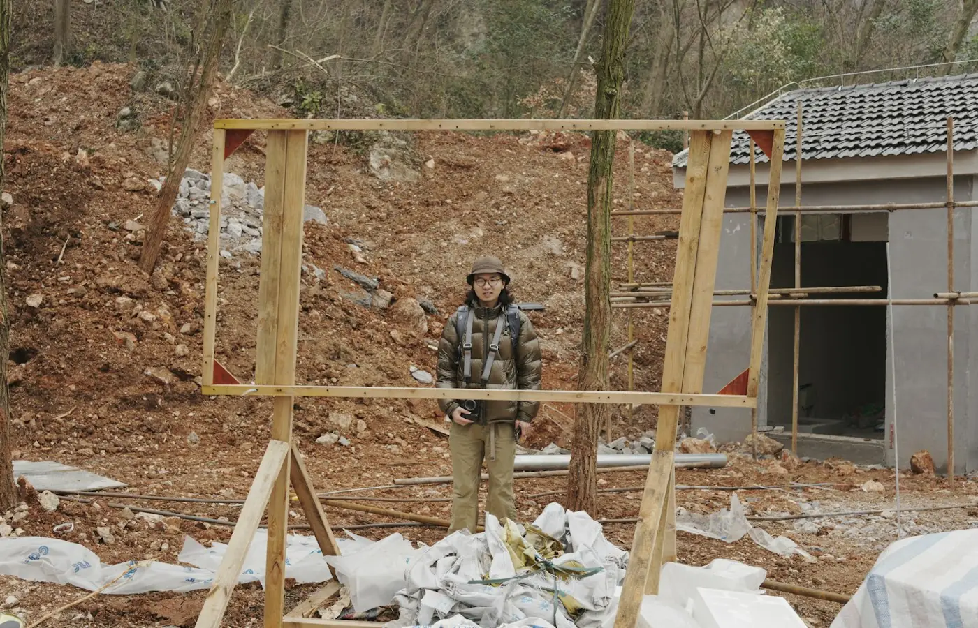 Timber wall framing going up in a yard beside an existing home for a small detached unit (stock photo)