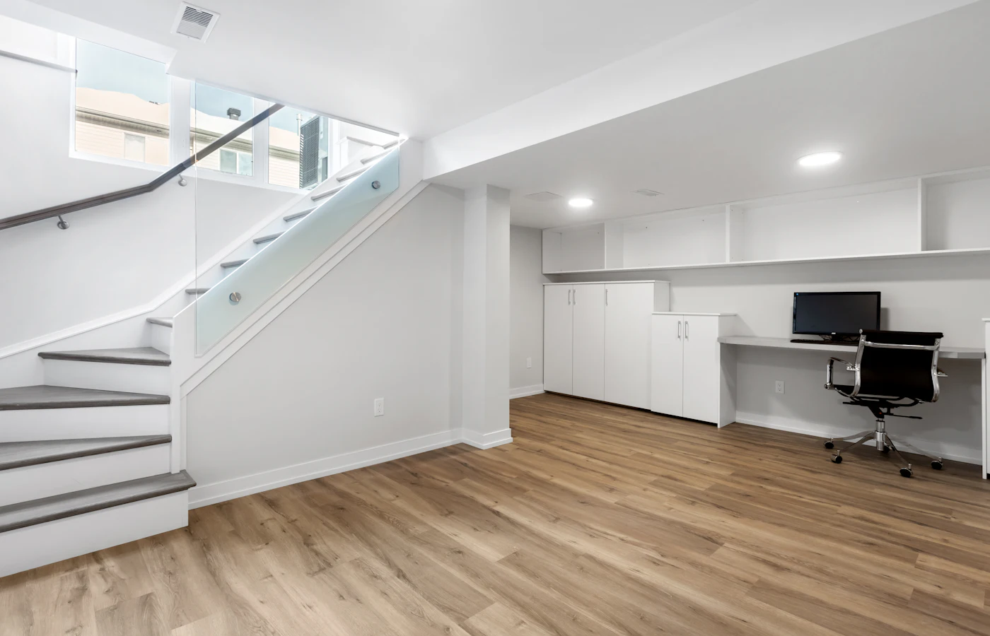 Finished basement with stairs, office and natural light (stock photo)
