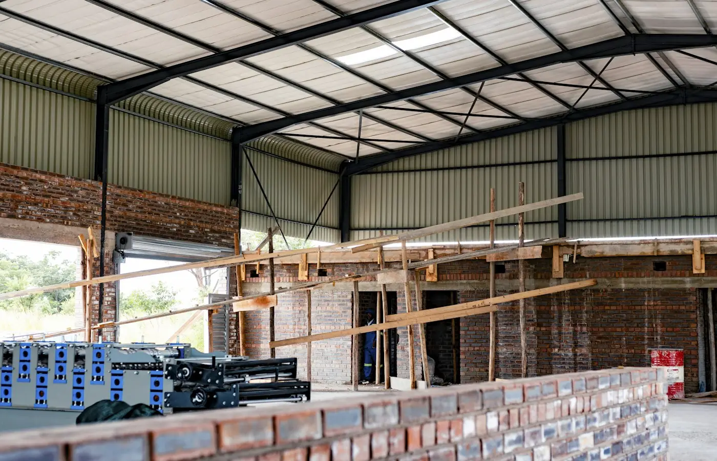 Commercial space mid build-out with steel roof framing, scaffolding and new walls (stock photo)