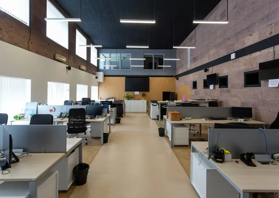 Open office interior with desks and brick accent wall (stock photo)